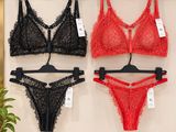 three women ' s lingersuits hanging on a wall in a store