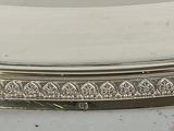 a silver plate that has a design on it