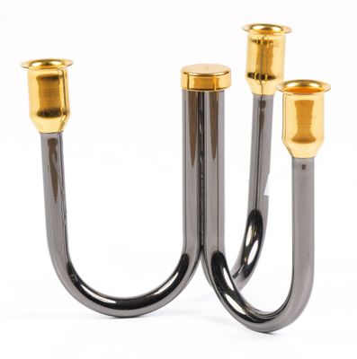 pair of black and gold candlesticks on a white background