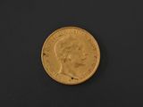 a close up of a gold coin on a black surface