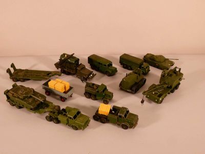 a lot of toy army vehicles on a white surface