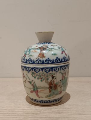 a small vase sitting on a table with a white background