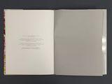 an open book with a picture of a cat sitting on top of it