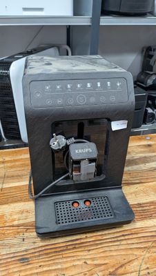 a coffee machine sitting on a table in a kitchen