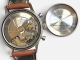 a close up of a watch with a leather strap