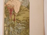an old book with a picture of a woman in a green dress