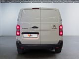 the rear of a white van is parked in a garage