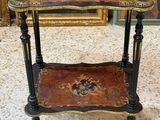 an image of a table with a painting on the wall behind it