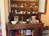 a wooden china cabinet with a glass door open