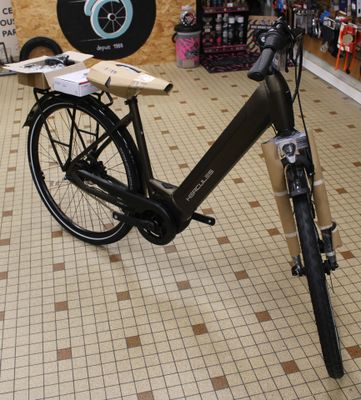 a bike that is parked in a store with a clock on the wall