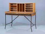 a wooden desk with a metal frame and a book shelf