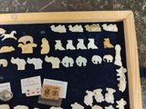 a shadow box with a display of various animal figurines in it