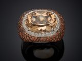 an orange and white diamond ring set in 18k white gold