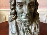 an image of a statue of a woman on a wooden table