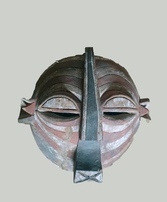an image of a mask made of clay