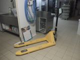 a fork lifter sitting on the floor in a kitchen