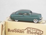 a green toy car sitting on top of a box