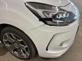 a close up of a white car parked in a parking lot