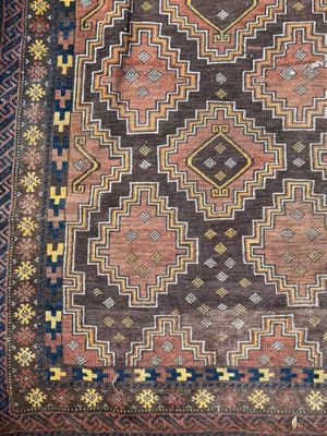 a brown and blue rug with a pattern on it
