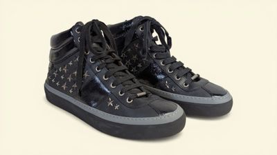 black high top sneakers with stars on them on a white background