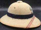 an old hat with a leather band and a feather on it
