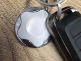 an apple keychain and a car key on a table
