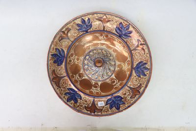 a gold plate with a blue and white design on it