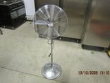 a fan that is sitting on the floor in the kitchen