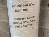 a roll of black wire wrapped in plastic on a pole