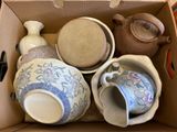 a box full of different types of teapots and cups