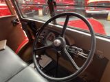 a steering wheel and dashboard of a car in a parking lot