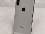 an apple iphone is sitting on a stand on a white surface