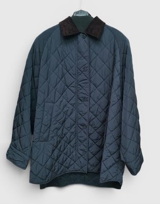 a close up of a jacket on a hanger on a wall