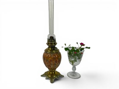 two candles that are next to a vase of flowers