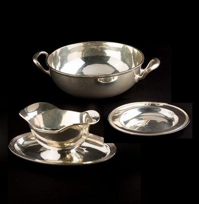 three pieces of silverware including a saucer, saucer and plate