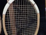 two tennis rackets sitting next to each other on a black surface