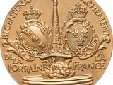 a close up of a gold coin with a tower in the background