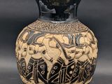 a black and white vase with a design on it