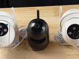 three cameras are sitting on a table with wires attached to them
