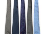 a set of four ties in different colors on a white background