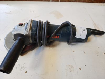 a close up of a drill on a table with a cord