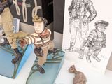 two figurines of soldiers on display next to a box