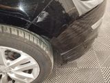 a close up of a car ' s front tire with a hole in it
