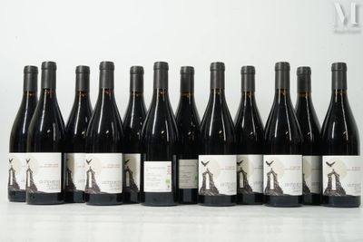 six bottles of wine are lined up in a row on a table