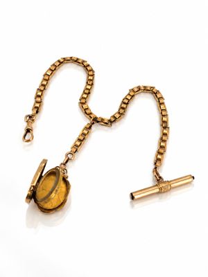 an image of a gold necklace with a tiger ' s eye on it