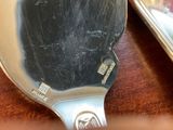 a silver spoon and a silver spoon on a table