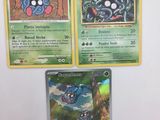 trois cartes Pokémon fixées au réfrigérateur à l'aide d'un aimant