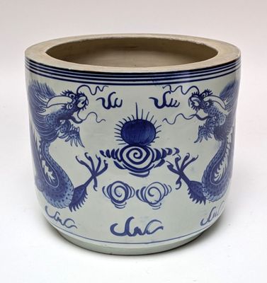 a blue and white vase with a dragon design on it