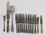 a lot of silverware on a table with a knife and fork
