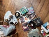 a pile of cds and other items on the floor